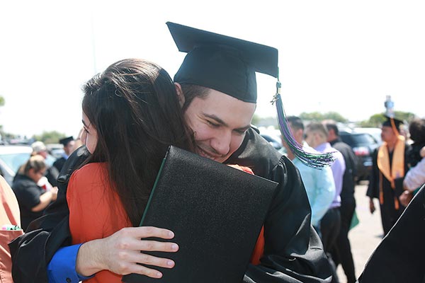 hugging graduate